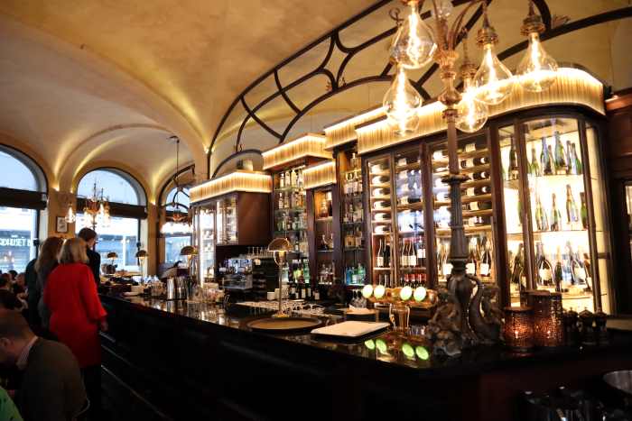 The Theater Cafe in central Oslo, an elegant venue with classic details, a classy bar, beautifully lit, with lots of guests and windowd to peak out at Oslo main street Karl Johan. 