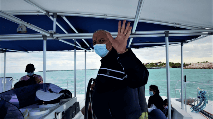 The captain of the diving boat driving and waving while we are off to a day of scuba diving outside Cayo Santa Maria