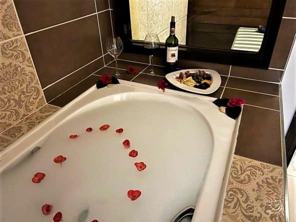 One afternoon I got back to this; a ready made bubble bath withrose petals, a bottle of wine, cheese and ham on the side of the bath tub - my butler had been there to visit. 