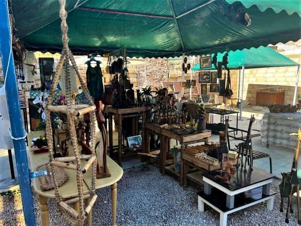 A market in Santa Clara full of locally made artwork under green parasols. 