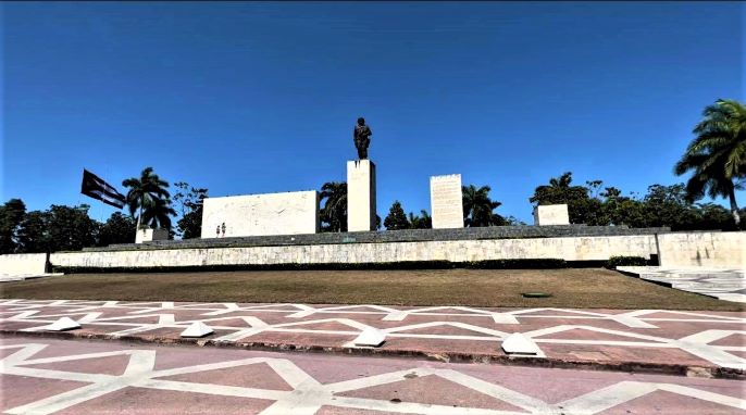 The impressive mausoleum of Che Guevara in Santa Clara Cuba, with an impressive statue on top of the actual mausoleum. Che Guevara gazing over the Plaza de la Revolution in Santa Clara, under a deep blue sky on a warm sunny summer day. 