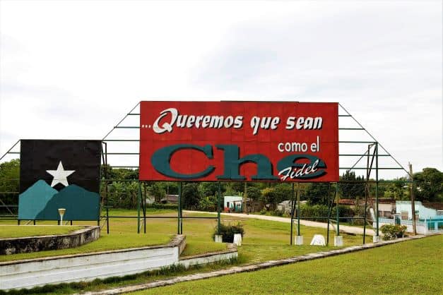 Big red propaganda poster in Cuba with slogans pro Che Guevara and Fidel Castro. 