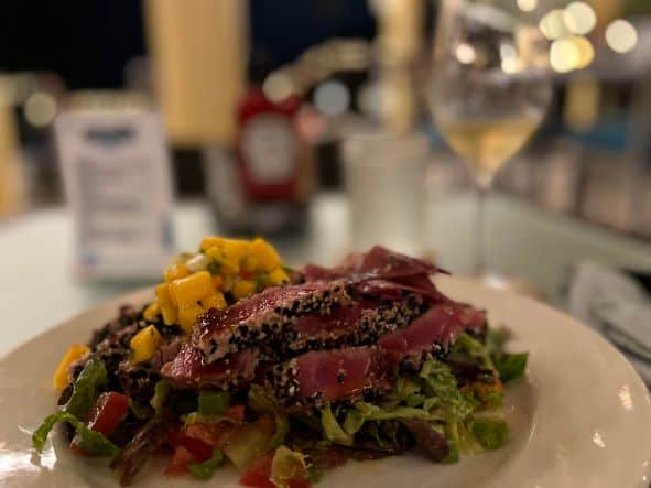 A delicious tuna salad at the Holiday Inn, the tuna fish is red in color, there is also lots of mango and acidic dressing on this perfect dish