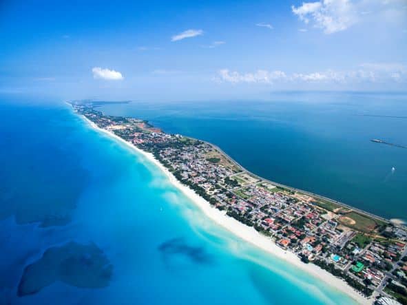 Varadero Peninsula on the northern shores of Cuba seen from the air. A long narrow string of land with crisp white sandy beaches all along the coastline, and the deep blue sea on all sides on a bright sunny summer day. 