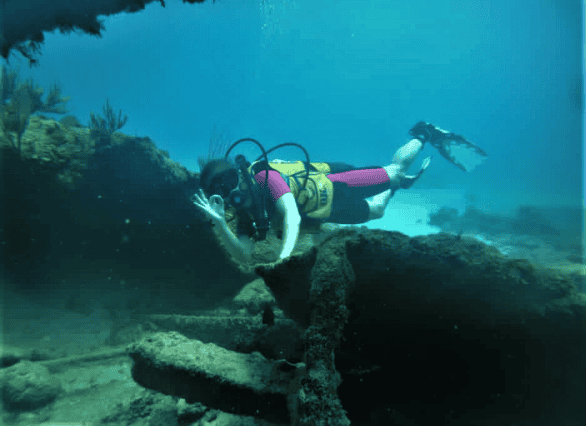 Scuba diver signing all well while diving in Havana Cuba, in crystal clear waters