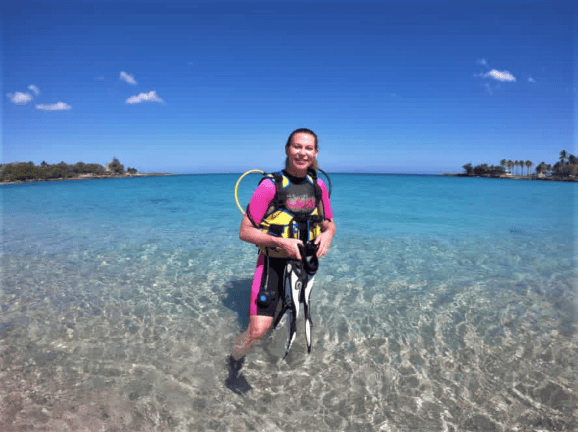 Photo of me right before we exit to go scuba diving on Bucaranao Beach, white sands, blue crystal clear water, bright blue sky, and an incredible summer day. 