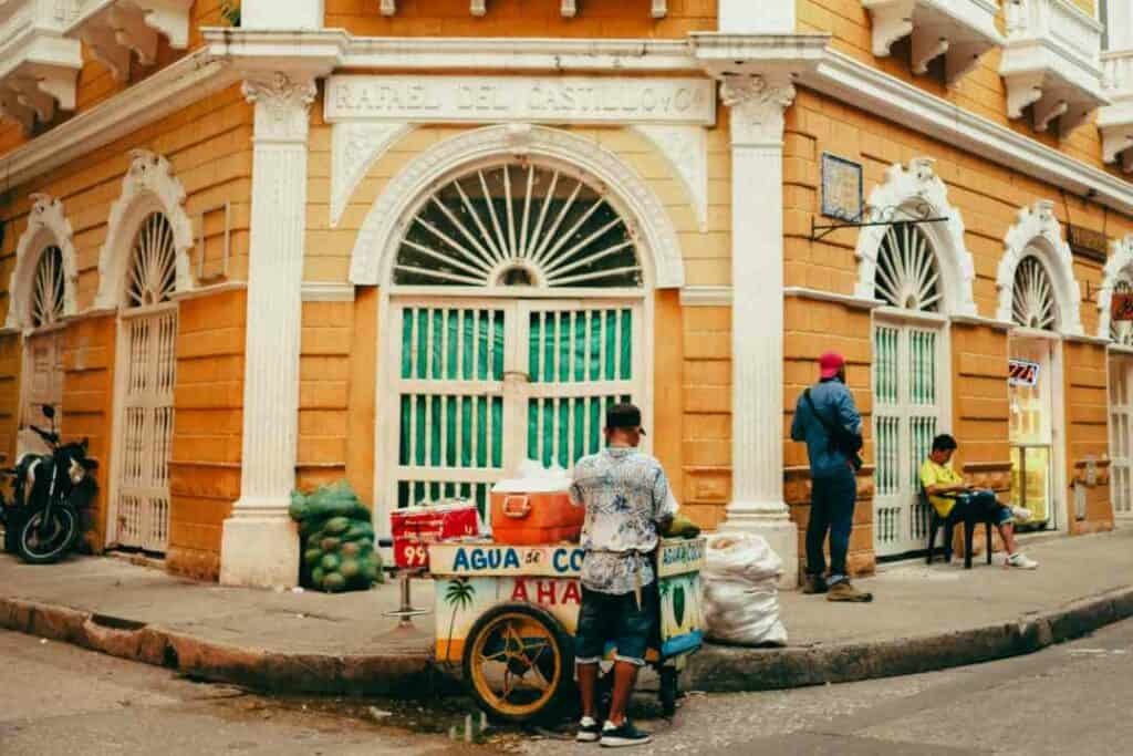 Taste the street food in the colonial town of Cartagena Colombia, among these yellow and white colonial houses where there is a bustling city life