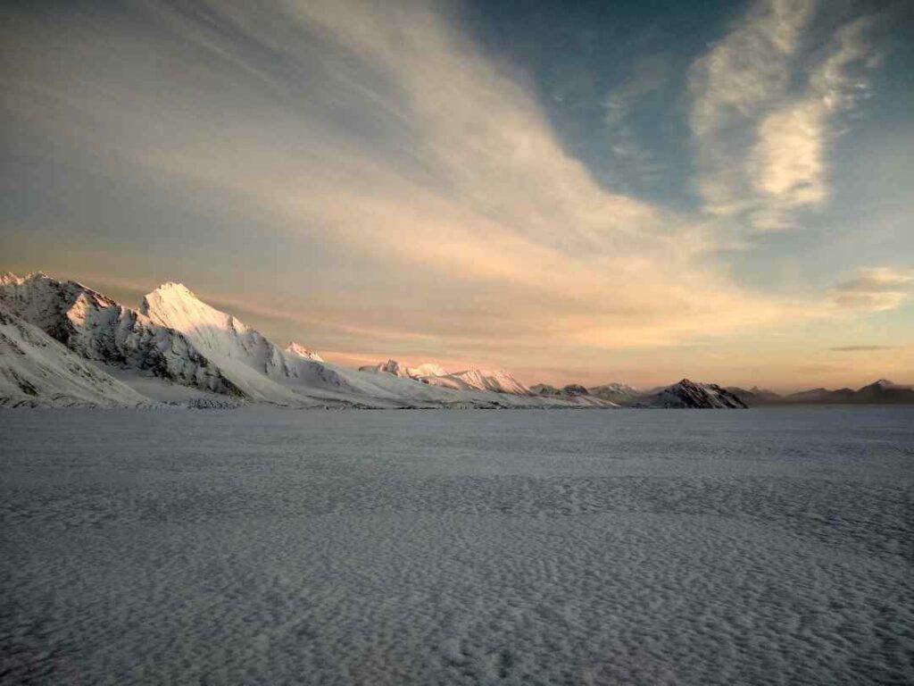 A white Svalbard glacier in the late and soft pinkish soft light