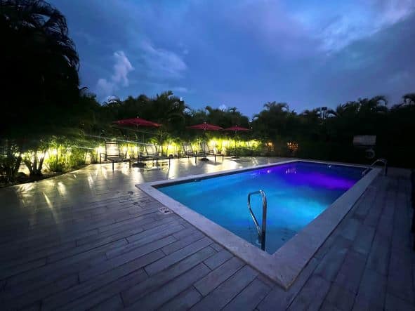 The blue beautifully lit pool at the Locale Hotel in Grand Cayman at night. 