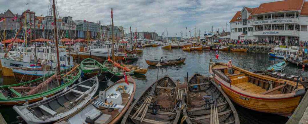 Photo from the Bergen Wharf old boats market day, with lots of old wooden boats scattered around the harbor like in the old days!