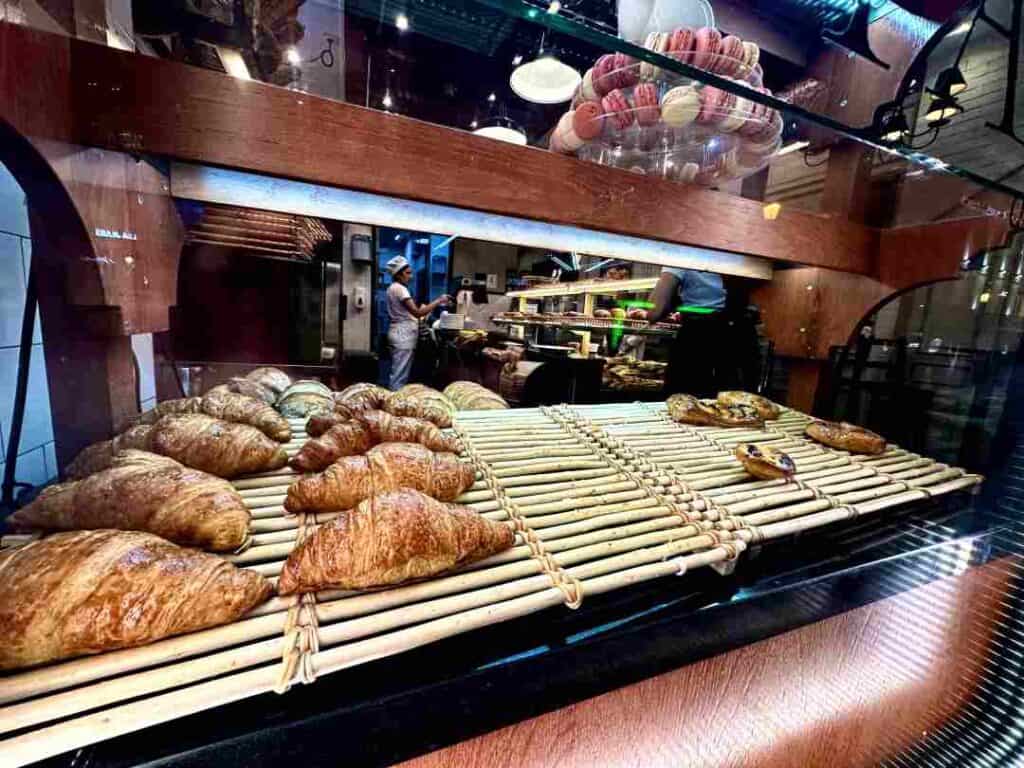 A tray with croissants and other pastry on display