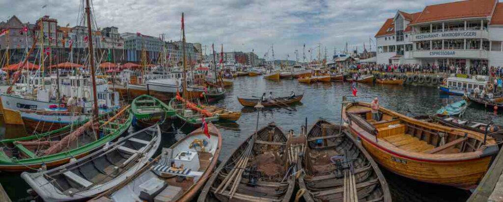 A harbor area with a myriad of old wooden small boats covering almost the entire water