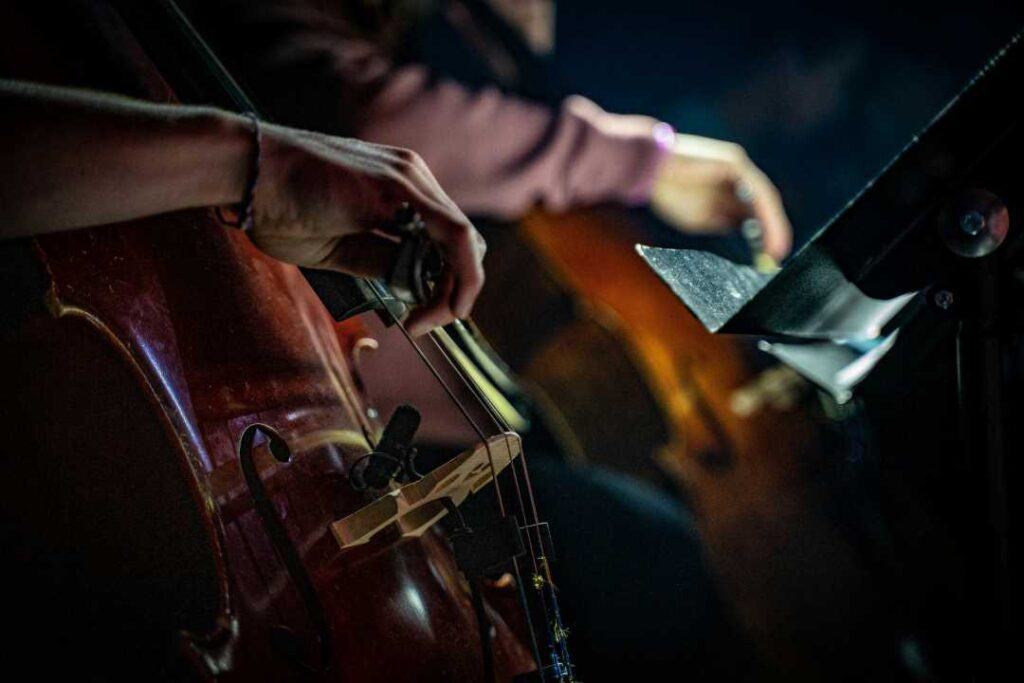 Close up of a violinist holding his bow to the instrument