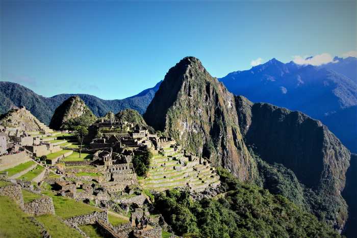 A mountain ruin area surrounded by high peaks on a bright sunny day