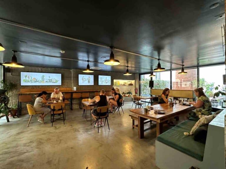 A hostel restaurant and working area with warm lighting and an inviting atmosphere