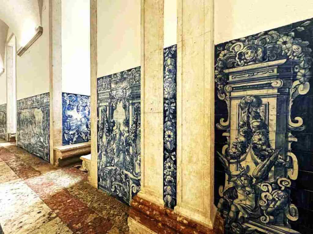 stunning blue tile wall art in an ancient building, with tiled floors and white stone columns