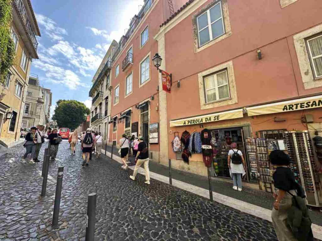 An old city street with cobblestones, surrounded by colorful old stone houses